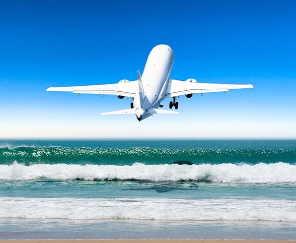 {"metadata_en_GB":{"alt-text":"A plane flying low above sea waves"},"metadata_en_AU":{"alt-text":"A plane flying low above sea waves"}}