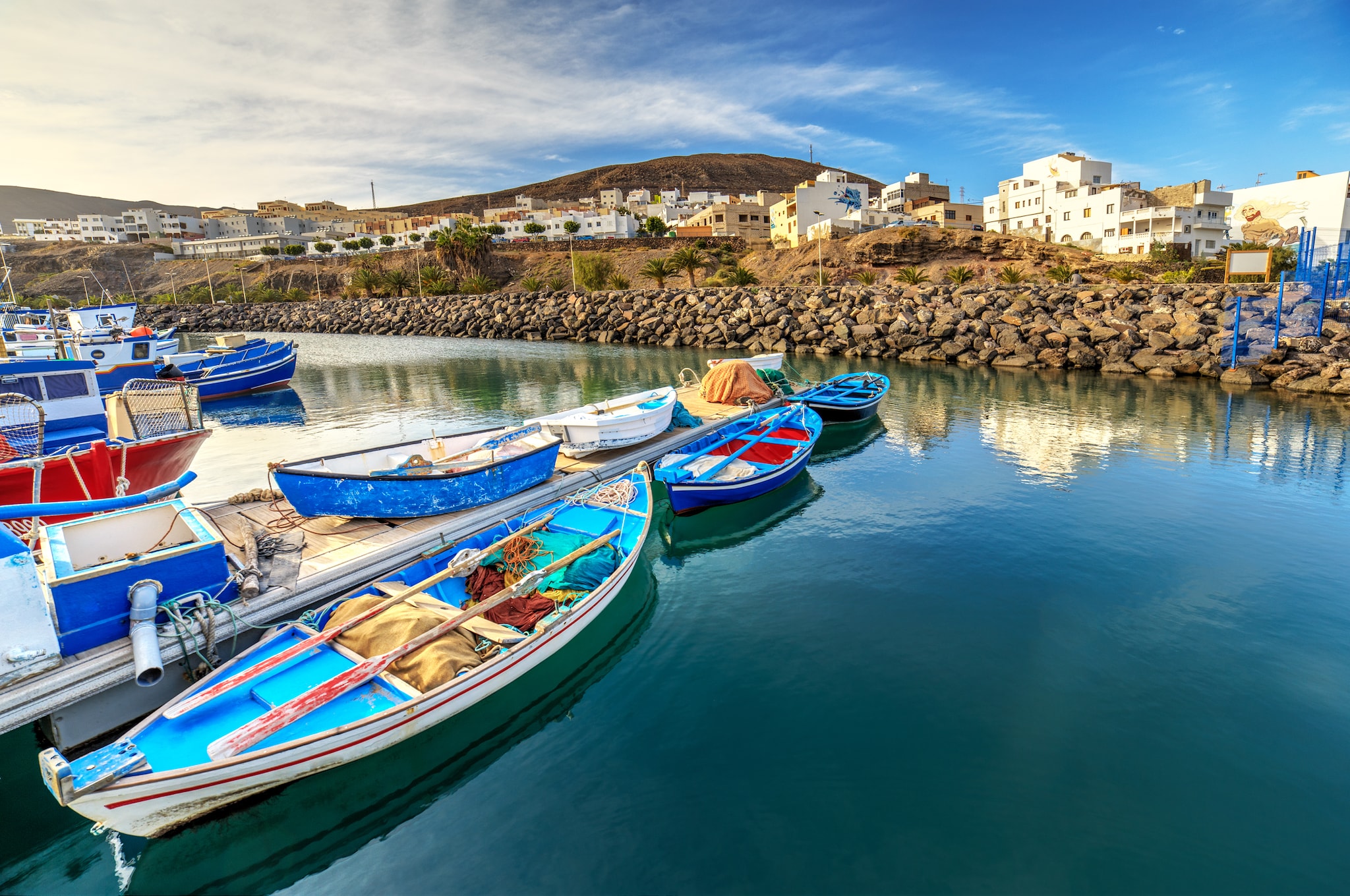 {"metadata_en_GB":{"alt-text":"Fishing boats in port in Gran Tarajal, Fuerteventura; Shutterstock ID 396643678"}}