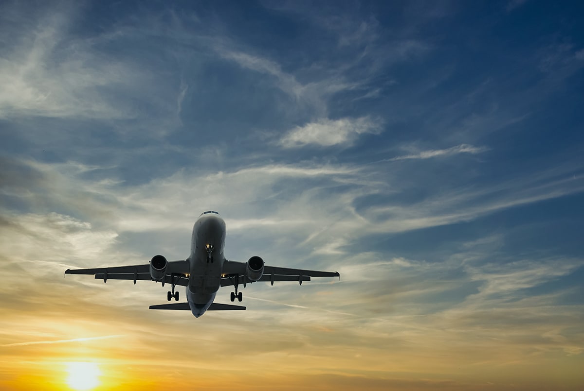 The plane against the blue sunset sky. The setting sun. Sunset.; Shutterstock ID 1936631263; project: po; job: po; client: po; other: