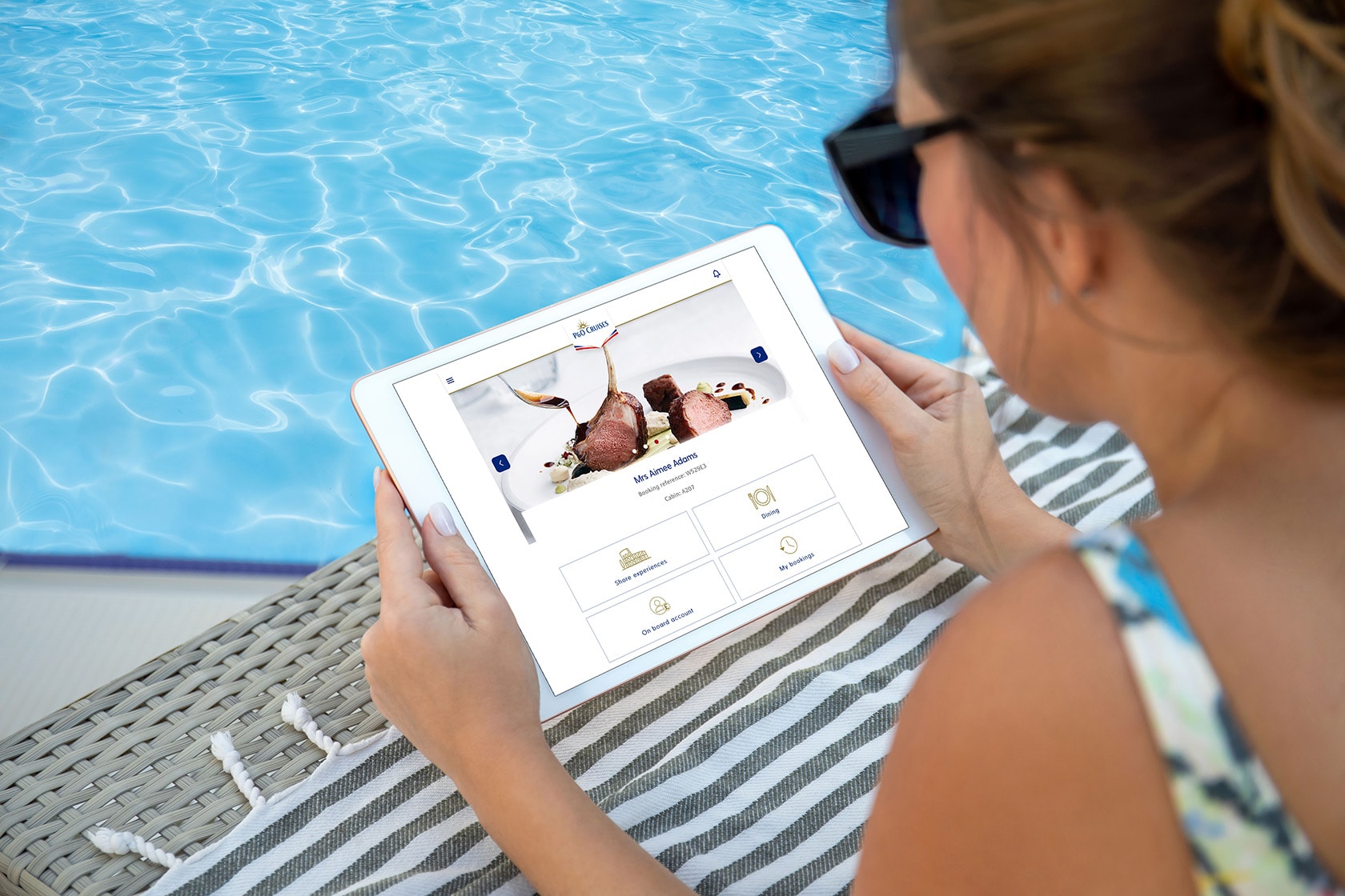 woman in hands holds computer tablet with isolated screen near the pool